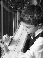 Photograph of Benjamin playing his Pilgrim lever harp